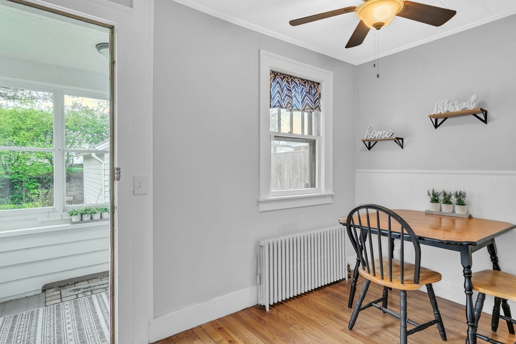108 Manchester Terrace Springfield, MA 01108 - Photo 26 of 40 a view of a dining room with furniture window and wooden floor