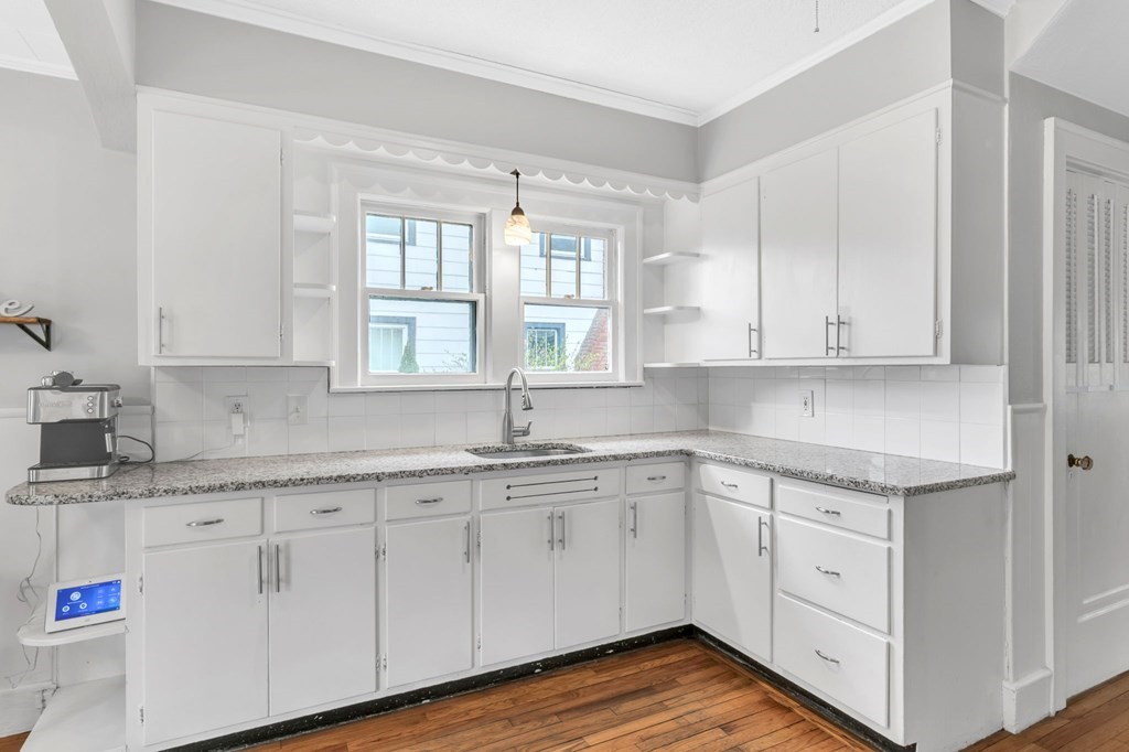 108 Manchester Terrace Springfield, MA 01108 - Photo 28 of 40 a kitchen with granite countertop white cabinets white appliances and sink