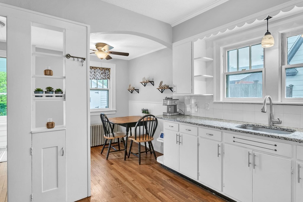 108 Manchester Terrace Springfield, MA 01108 - Photo 29 of 40 a kitchen with granite countertop white cabinets and white appliances