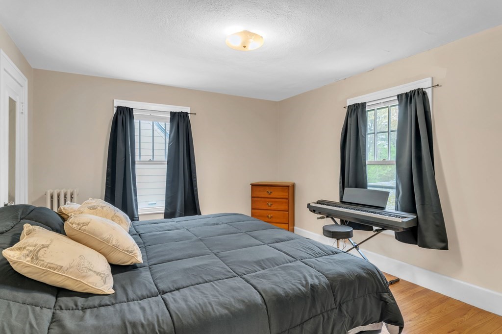 108 Manchester Terrace Springfield, MA 01108 - Photo 32 of 40 a bedroom with a bed and wooden floor