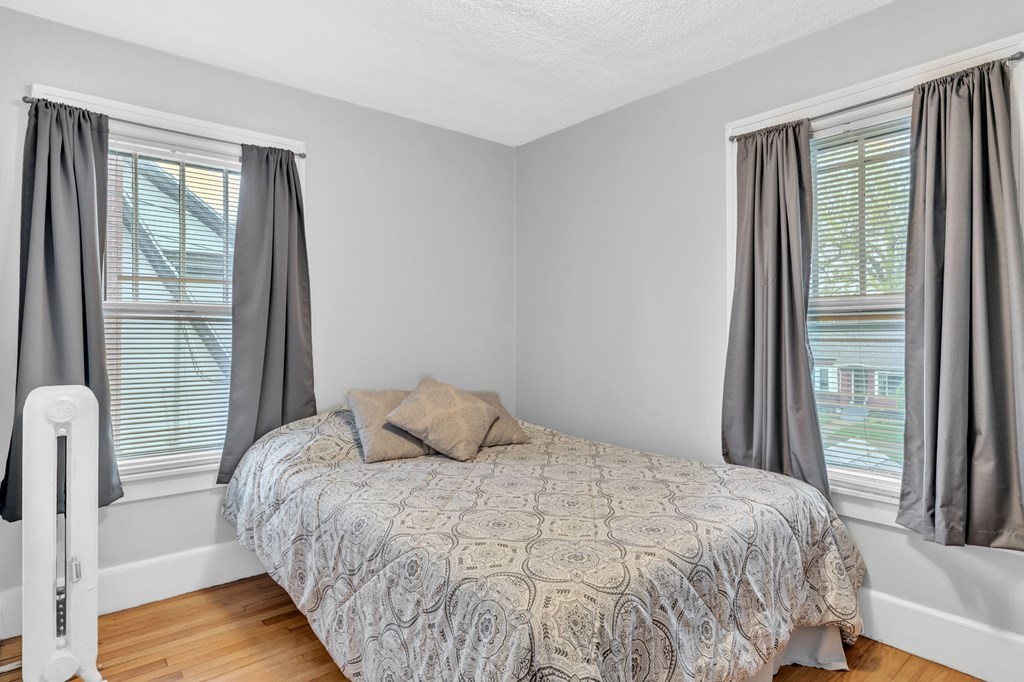108 Manchester Terrace Springfield, MA 01108 - Photo 34 of 40 a bedroom with a bed and a large window