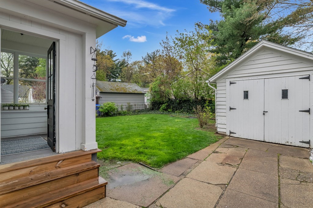 108 Manchester Terrace Springfield, MA 01108 - Photo 5 of 40 a view of backyard with potted plants and a bench