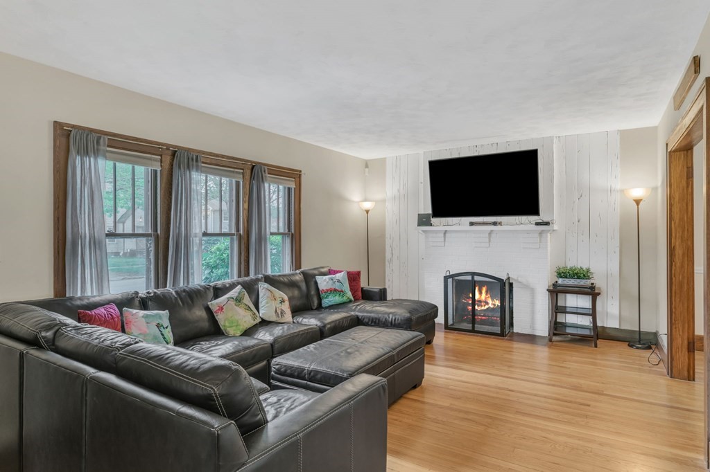 108 Manchester Terrace Springfield, MA 01108 - Photo 8 of 40 a living room with furniture a fireplace and a flat screen tv