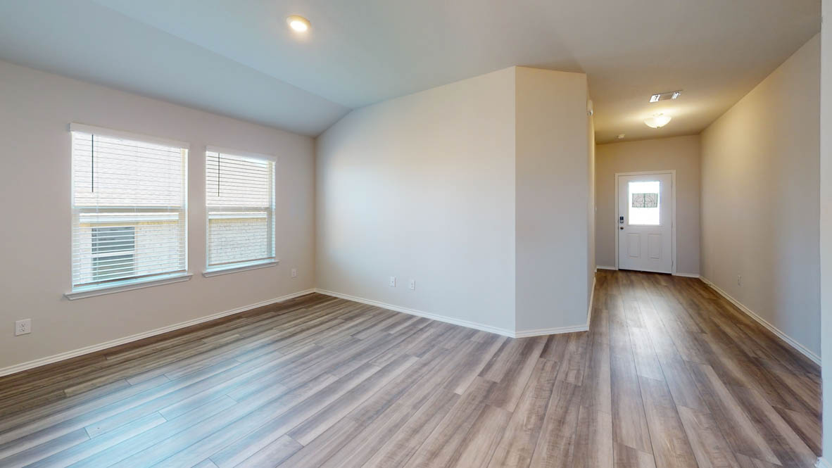 412 Creekfall Road Burnet, TX 78611 - Photo 2 of 16 a view of an empty room with wooden floor and a window