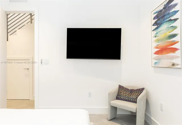 a bedroom with a bed and wall painting