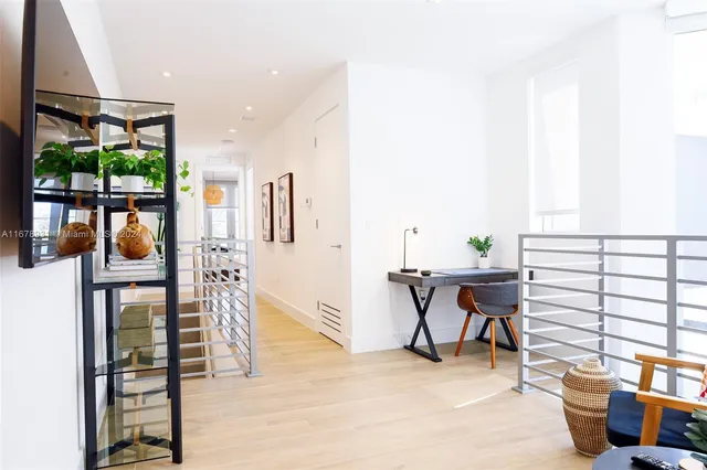 a bedroom with a large bed and a flat tv screen on dresser