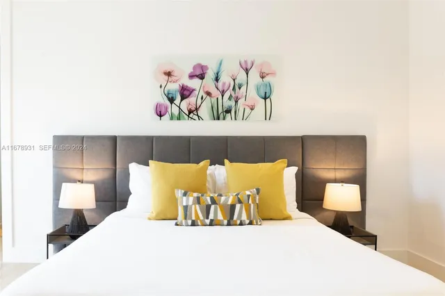 a bedroom with a bed and a lamp