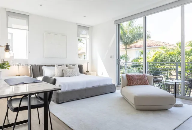 a living room with furniture and a floor to ceiling window