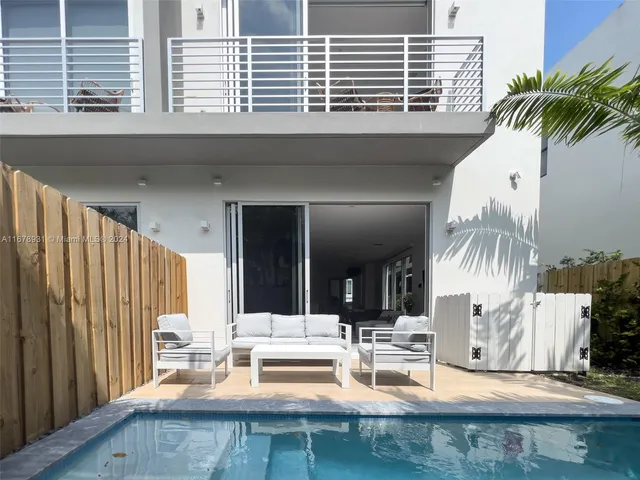 a vase of flowers sitting on a wooden floor