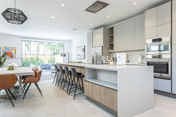 a kitchen with a table chairs stove and cabinets
