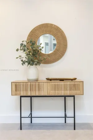 a living room with furniture a lamp and a table