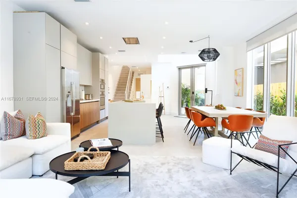 a kitchen with a table chairs sink and cabinets