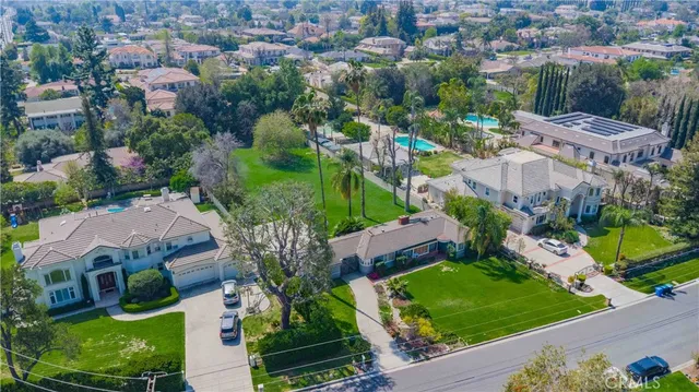 an aerial view of multiple houses with yard