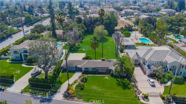 an aerial view of multiple houses with yard