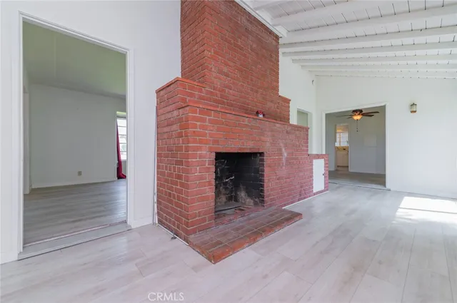 a view of an empty room and fire place