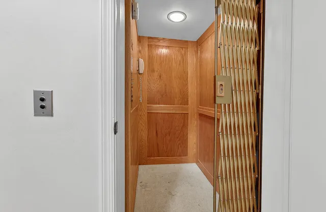 a room with lots of books and a large mirror