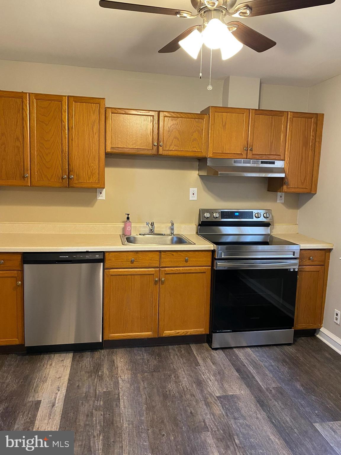 258 Birch Street Penns Grove, NJ 08069 - Photo 15 of 41 a kitchen with granite countertop a stove top oven a sink and cabinets