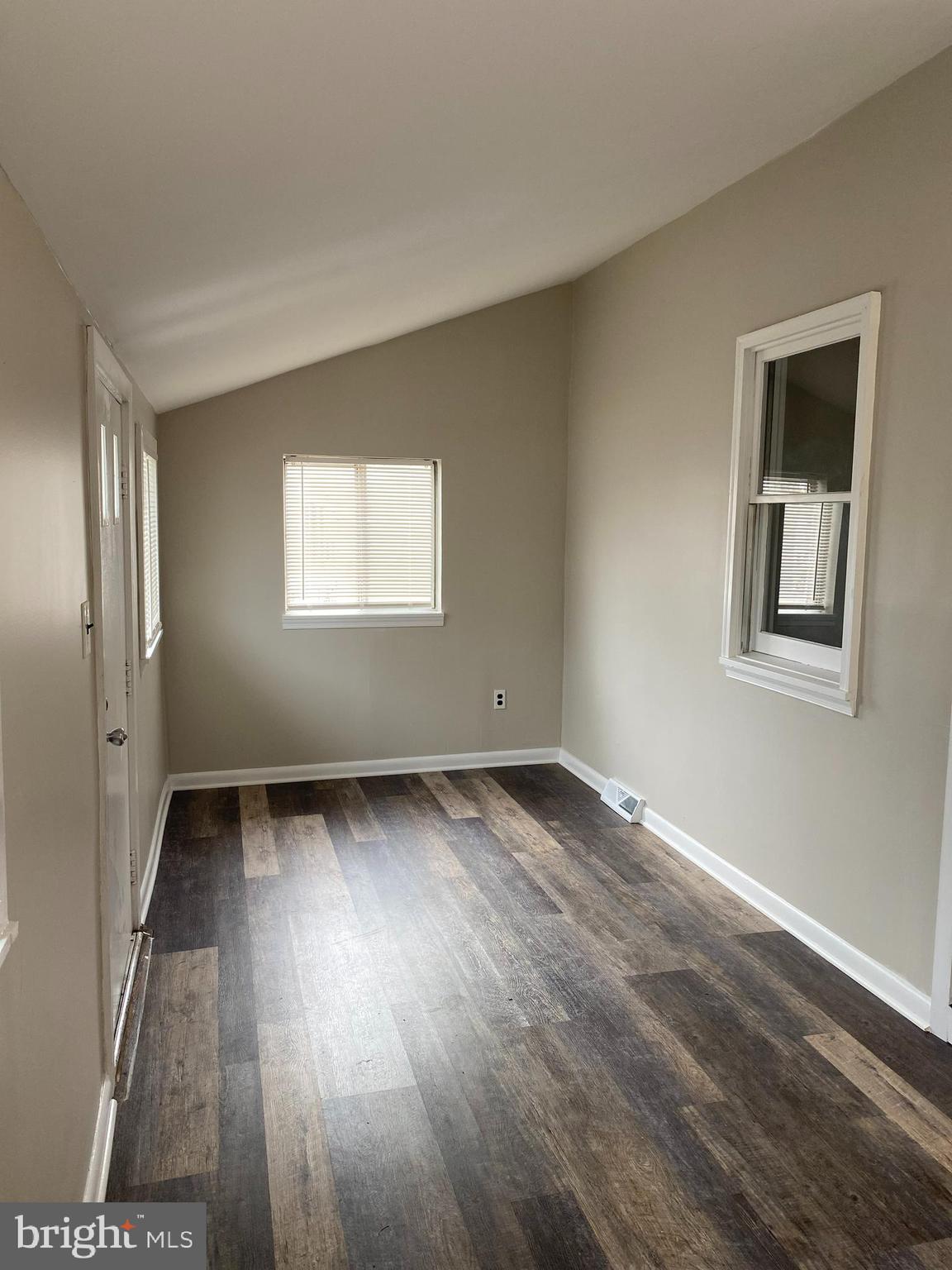 258 Birch Street Penns Grove, NJ 08069 - Photo 7 of 41 a view of an empty room with wooden floor and a window