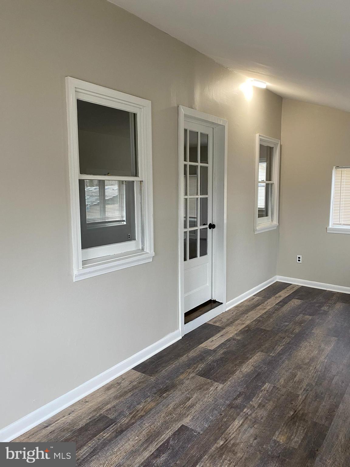 258 Birch Street Penns Grove, NJ 08069 - Photo 8 of 41 a view of an empty room with wooden floor and a window