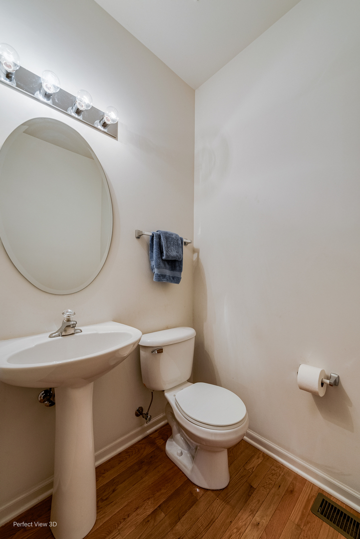 1606 Creekside Circle Minooka, IL 60447 - Photo 12 of 30 a bathroom with a toilet a sink and mirror
