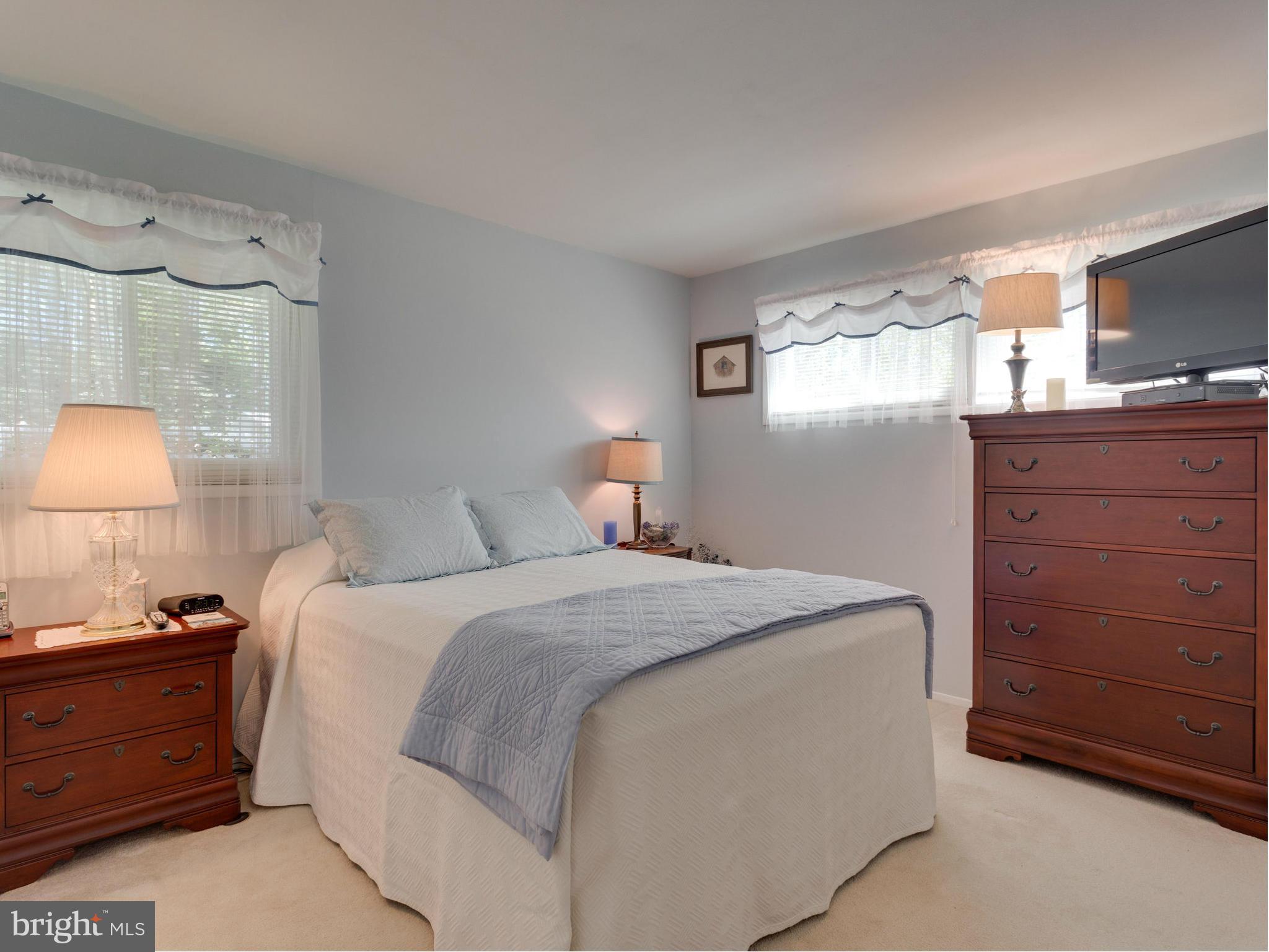 5218 Garner Street Springfield, VA 22151 - Photo 13 of 29 a bedroom with a bed and a tv on the dresser