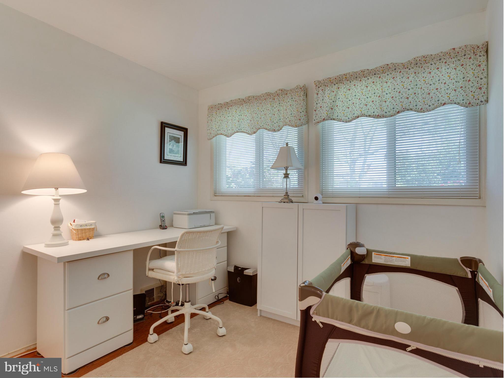 5218 Garner Street Springfield, VA 22151 - Photo 17 of 29 a view of a workspace with furniture and a lamp