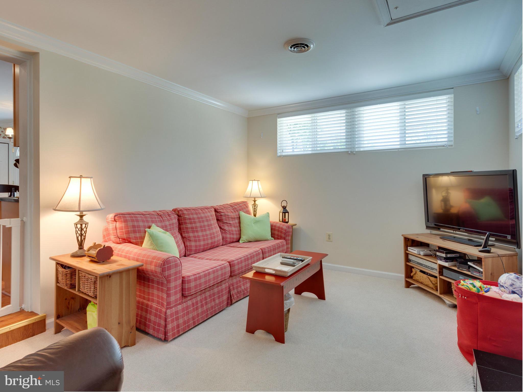 5218 Garner Street Springfield, VA 22151 - Photo 18 of 29 a living room with furniture and a flat screen tv