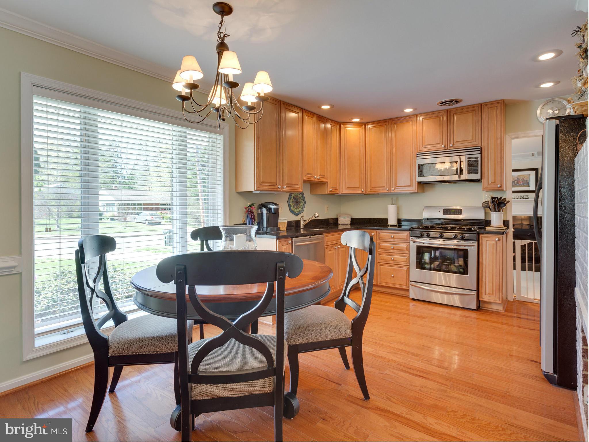 5218 Garner Street Springfield, VA 22151 - Photo 3 of 29 a dining room filled chandelier and wooden floor