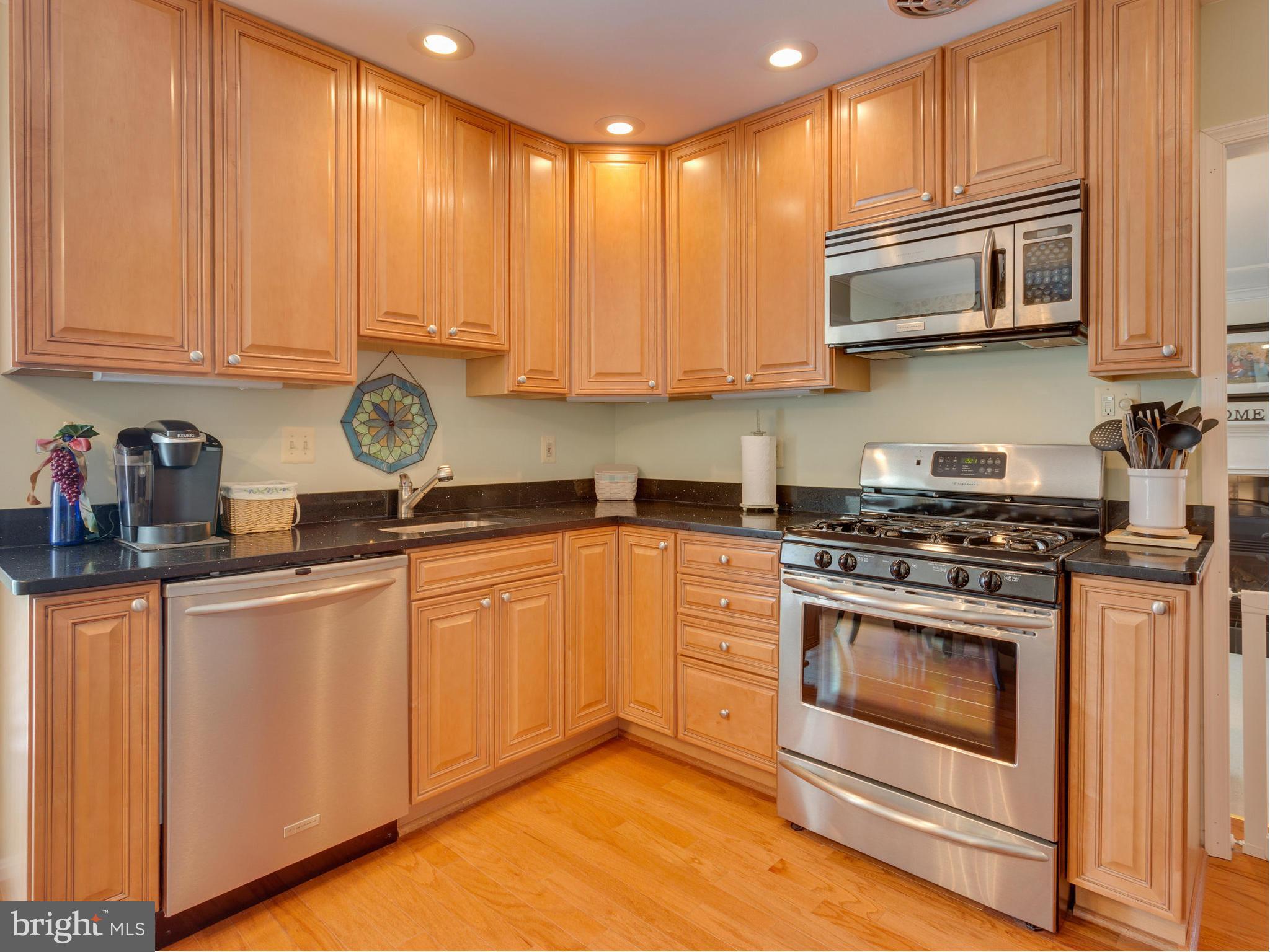5218 Garner Street Springfield, VA 22151 - Photo 4 of 29 a kitchen with stainless steel appliances granite countertop a stove a sink and a microwave