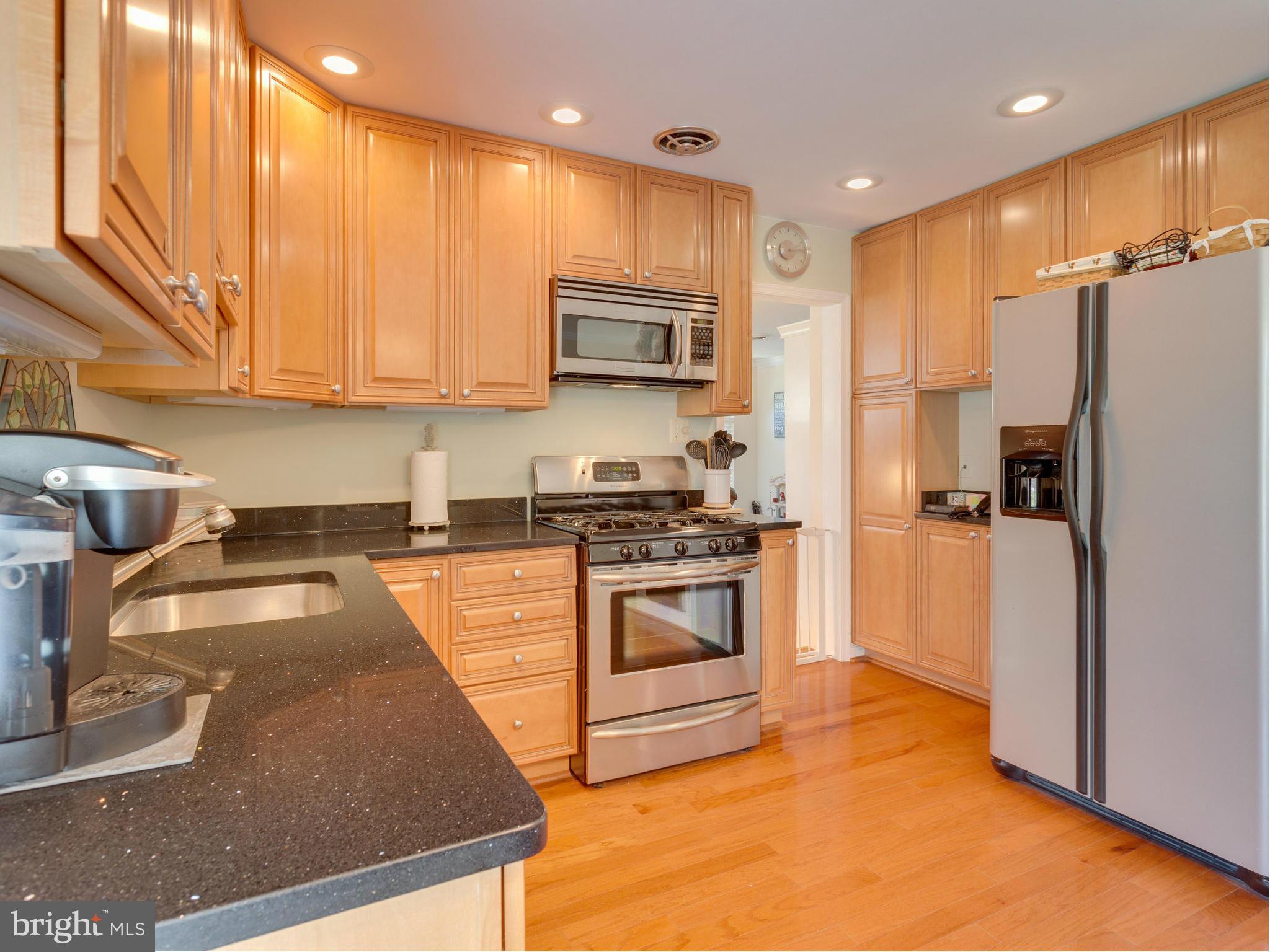 5218 Garner Street Springfield, VA 22151 - Photo 7 of 29 a kitchen with a refrigerator a sink and cabinets
