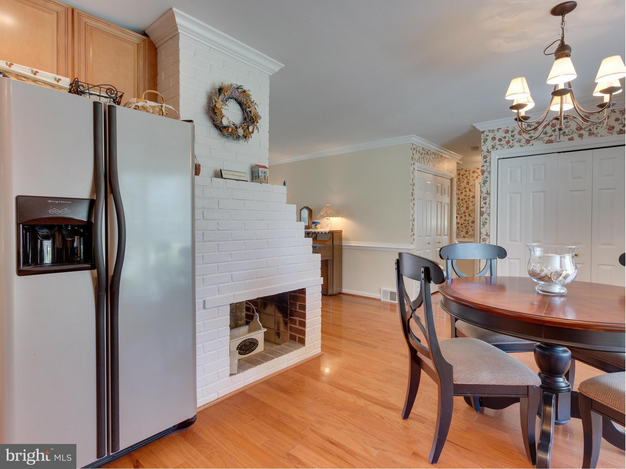 5218 Garner Street Springfield, VA 22151 - Photo 8 of 29 a dining room with furniture wooden floor a chandelier