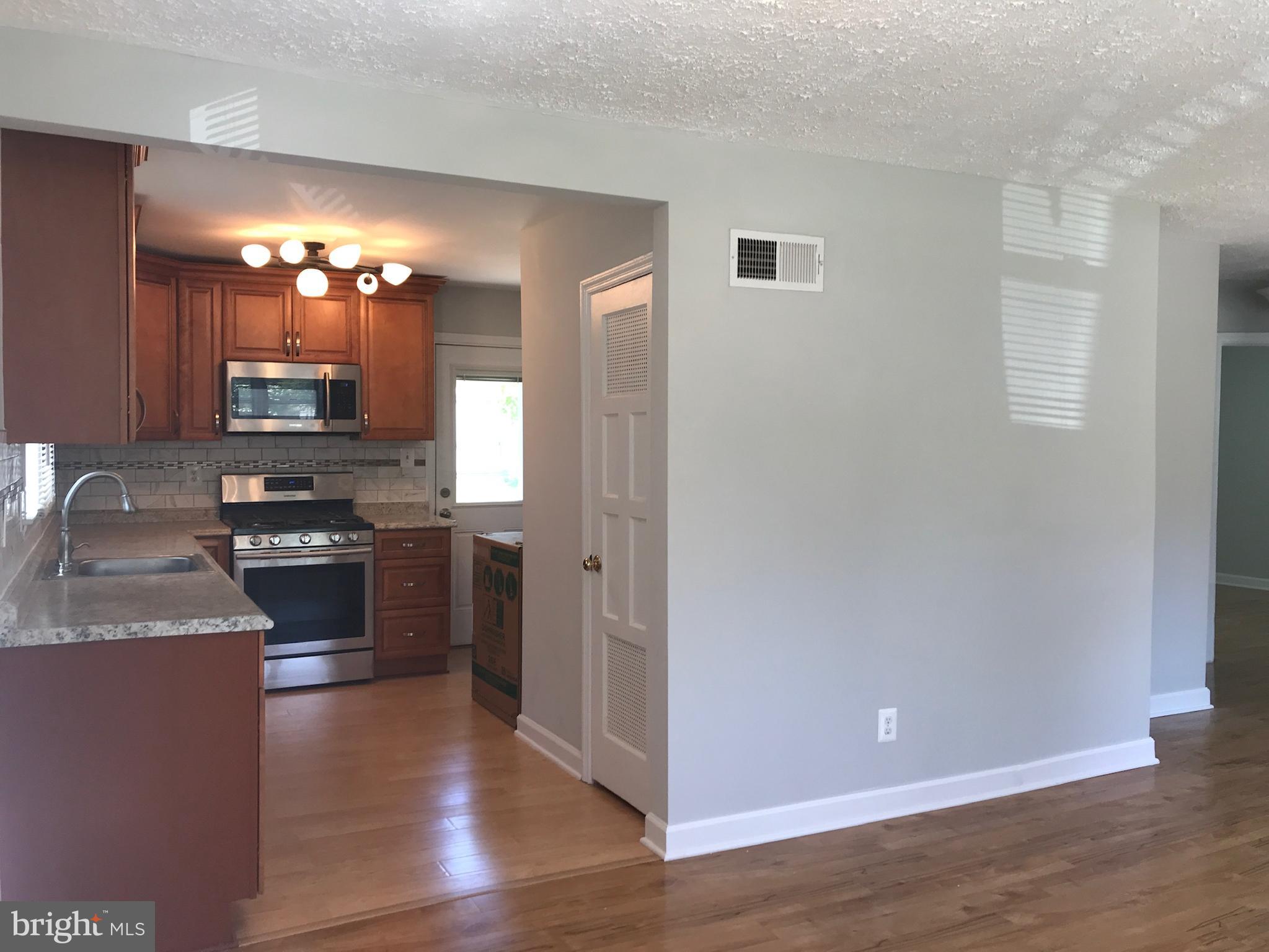 3134 Dashiell Road Falls Church, VA 22042 - Photo 9 of 10 a kitchen with granite countertop a stove and a refrigerator