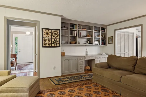 a living room with a couch and a bookshelf