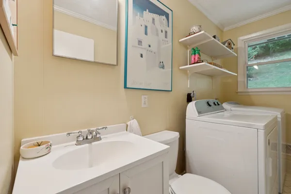 a bathroom with a sink toilet and mirror