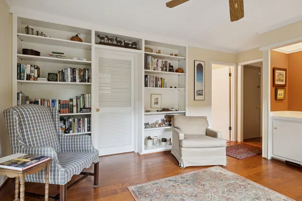 a living room with furniture and a book shelf