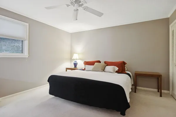 a bedroom with a bed lamp and a bookshelf