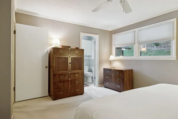 a bedroom with a bed and a dresser