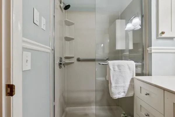 a bathroom with a mirror and a shower