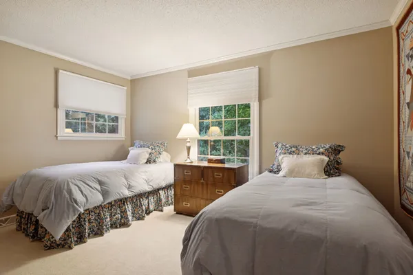 a bedroom with a large bed and a window