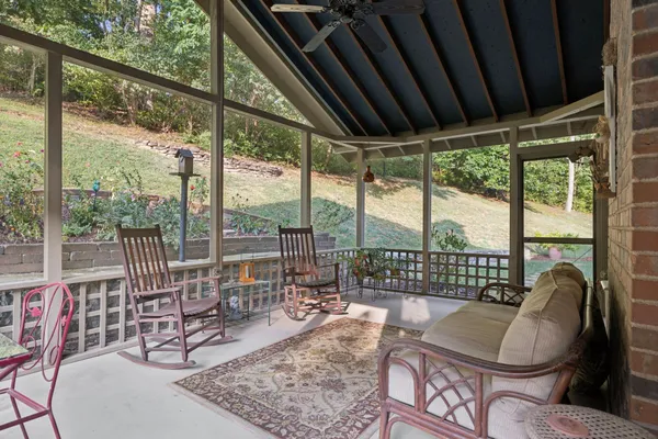 a living room with patio furniture and a large window