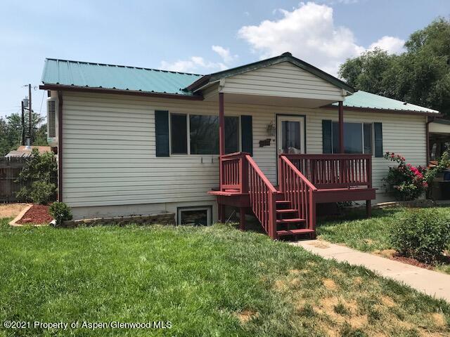 207 Ash Avenue Rifle, CO 81650 - Photo 1 of 21 a front view of a house with a garden