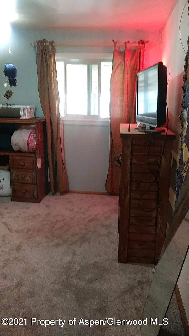 207 Ash Avenue Rifle, CO 81650 - Photo 11 of 21 a room with furniture and a flat screen tv