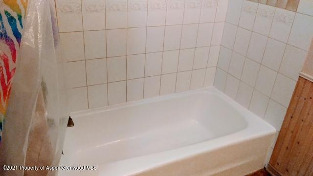 207 Ash Avenue Rifle, CO 81650 - Photo 17 of 21 a bathroom with a bathtub