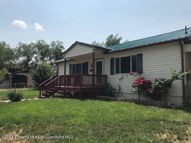 207 Ash Avenue Rifle, CO 81650 - Photo 2 of 21 a view of a house with a yard and sitting area