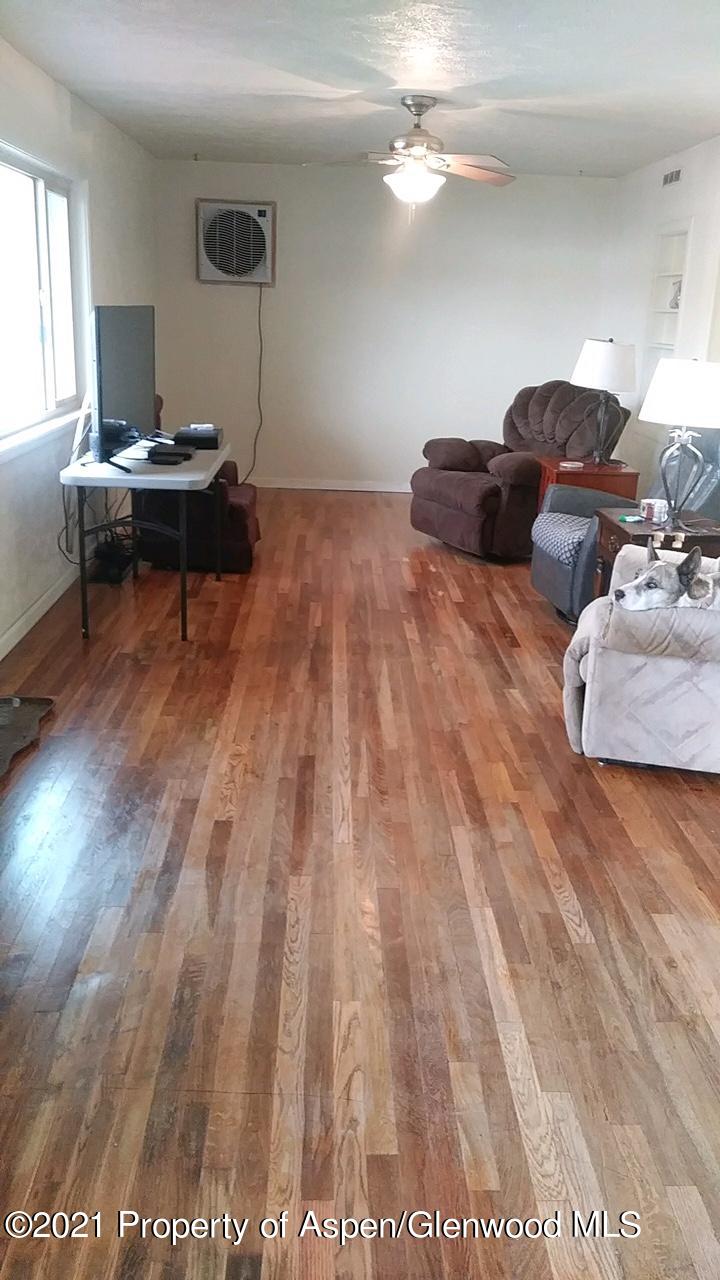 207 Ash Avenue Rifle, CO 81650 - Photo 3 of 21 a living room with furniture and a wooden floor