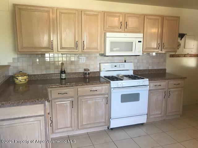 207 Ash Avenue Rifle, CO 81650 - Photo 5 of 21 a kitchen with white cabinets and white appliances
