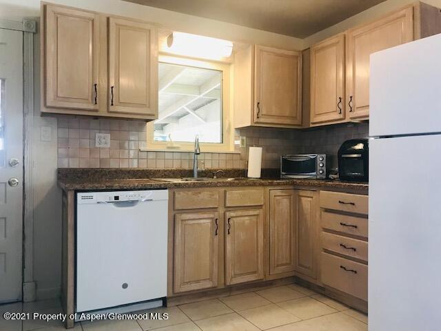 207 Ash Avenue Rifle, CO 81650 - Photo 6 of 21 a kitchen with granite countertop cabinets stainless steel appliances and a sink