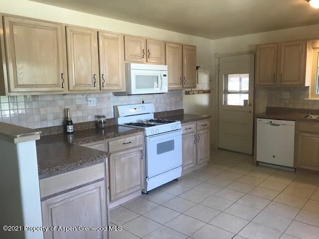 207 Ash Avenue Rifle, CO 81650 - Photo 7 of 21 a kitchen with a sink stove and cabinets