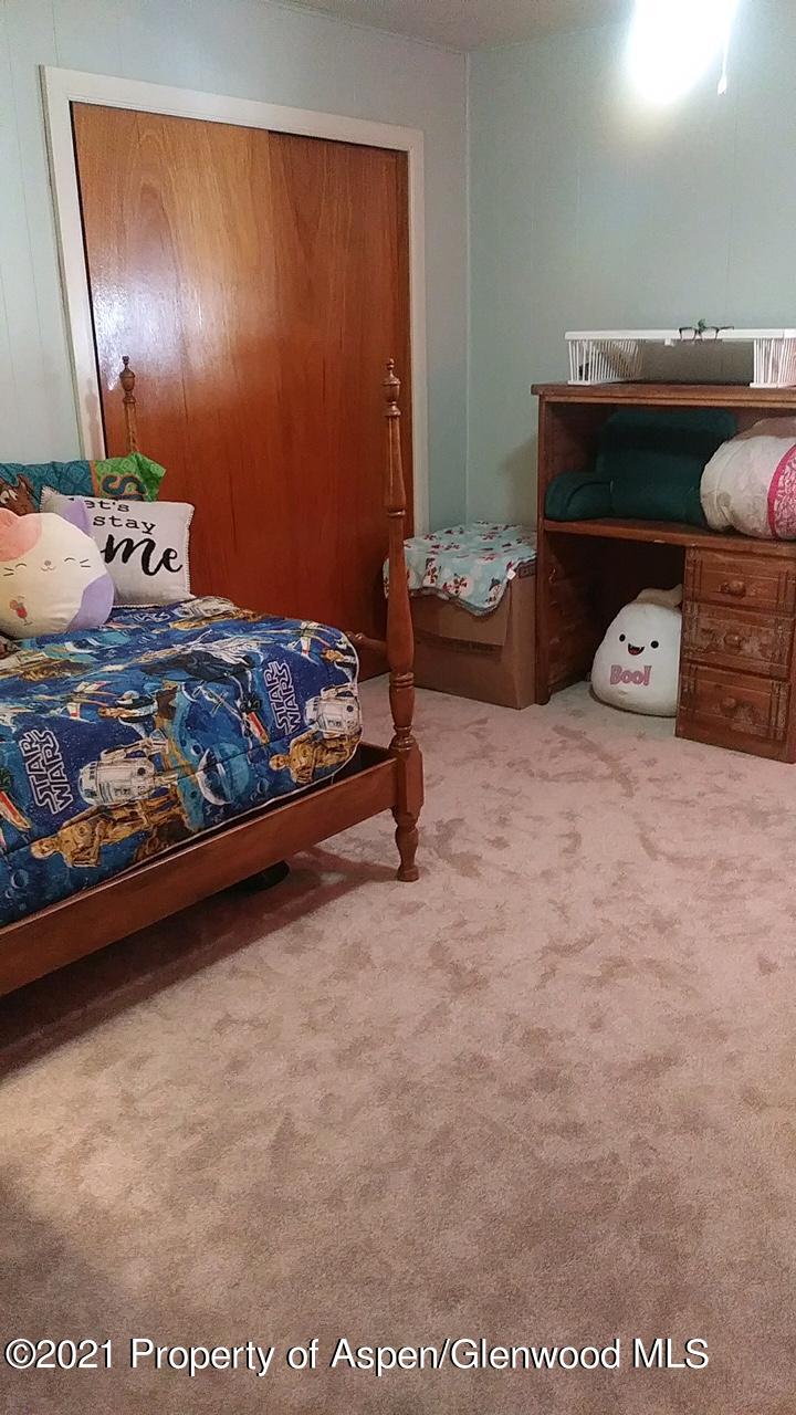 207 Ash Avenue Rifle, CO 81650 - Photo 8 of 21 a bed sitting in a bedroom next to a window