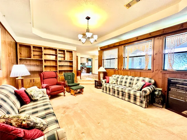 a bedroom with furniture and large window